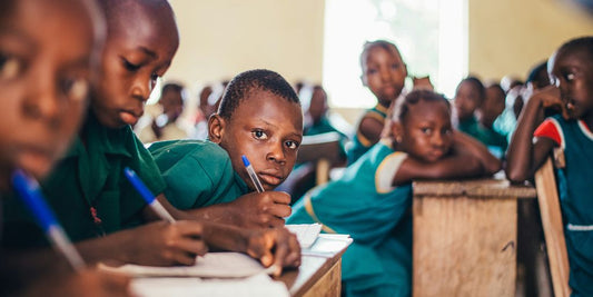 children writing in books