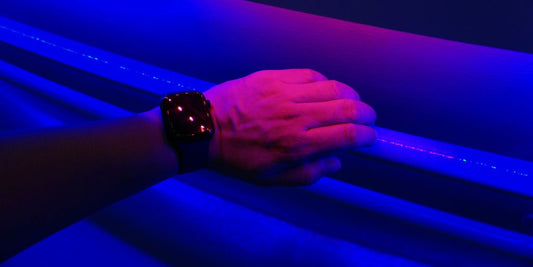 a person's hand holding onto a blue light