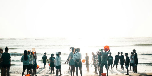 a group of people standing on a beach