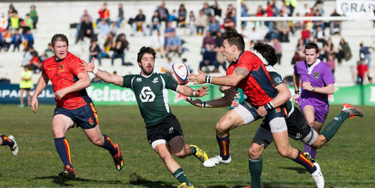 five men playing rugby during daytime