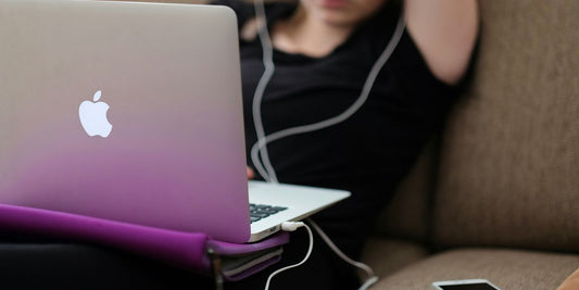 woman sitting on sofa with MacBook Air