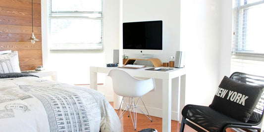 white wooden desk near bed inside the room